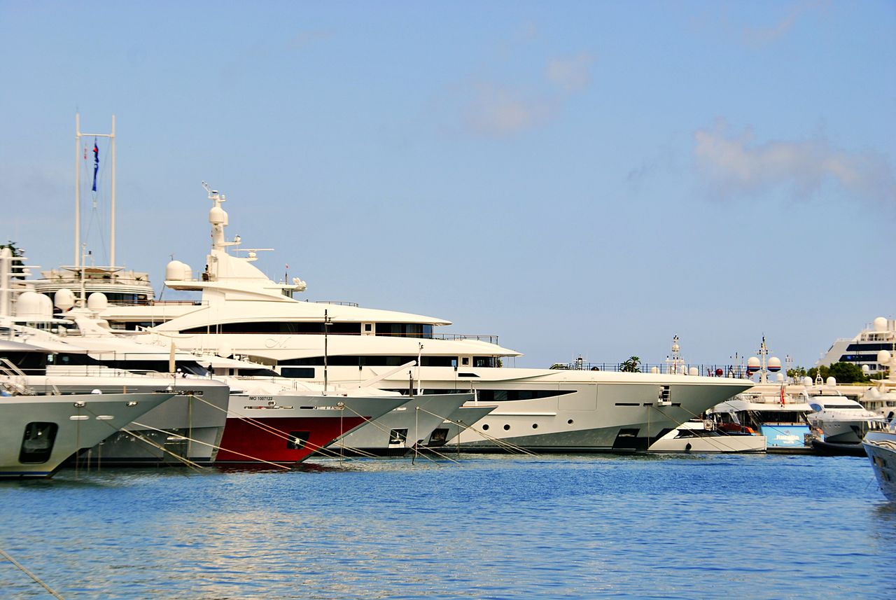 Stunning view of luxury yachts docked in the sunny Marina of Monaco.