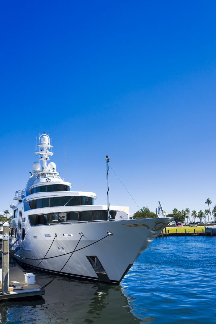 about-us-01 Stunning view of a luxury yacht docked in Fort Lauderdale under clear blue skies.